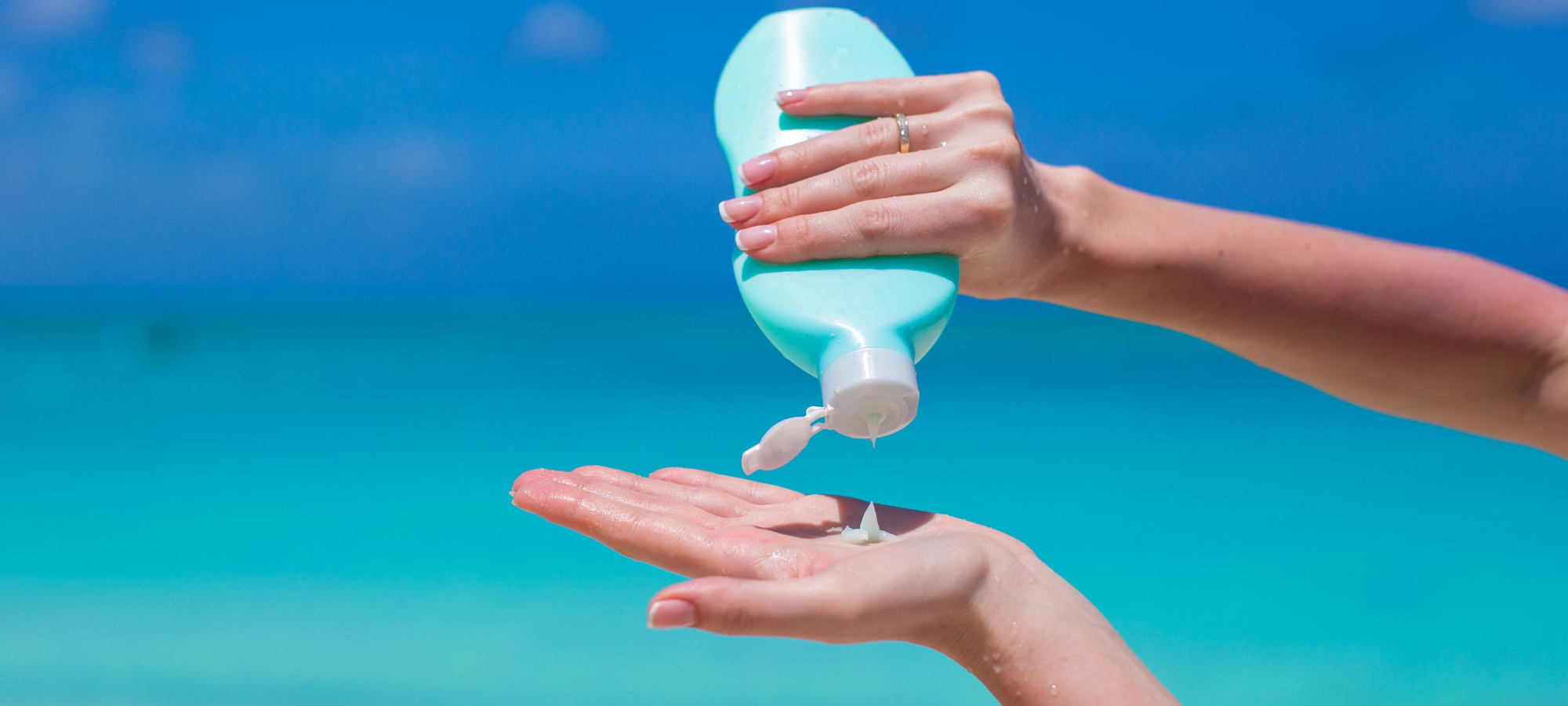 lady pouring sunscreen onto hand